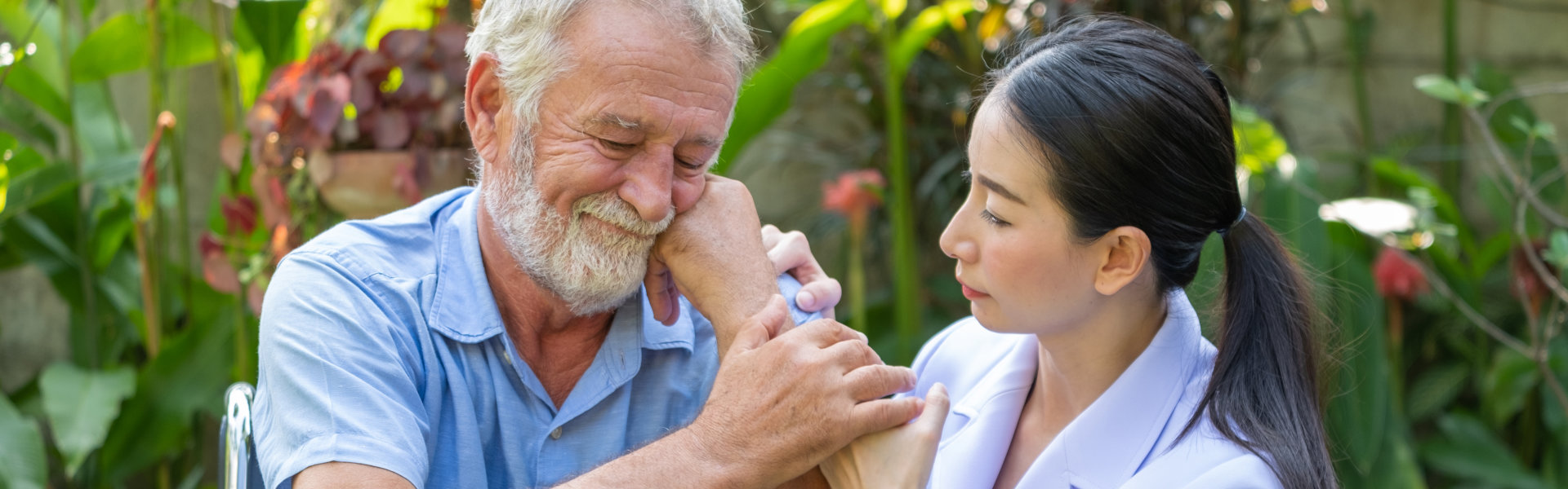 elderly man holding his caregiver dearly